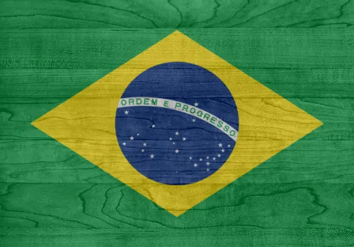 Brazilian flag painted over a textured green wooden surface